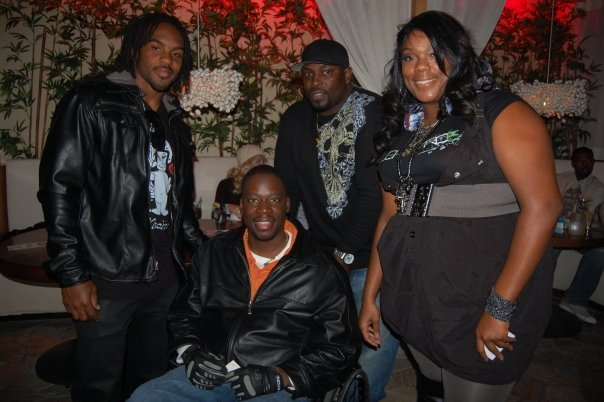 Dante Hughes and Nikko Goudeau pose with guests from the event